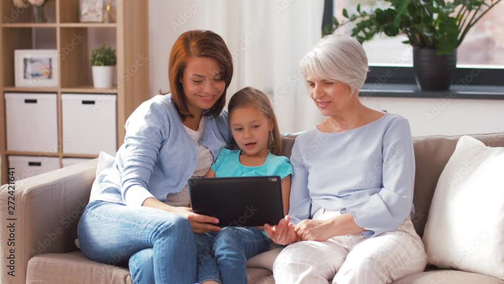 family, technology and tree generations concept - happy mother, daughter and grandmother having video call tablet computer and showing thumbs up at home family, technology and tree generations concept - happy mother, daughter and grandmother having video call tablet computer and showing thumbs up at home
