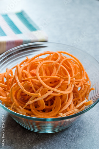 Spiralized Raw Sweet Potato in Glass Bowl Ready to Cook / Use. photo