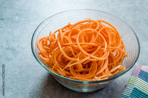 Spiralized Raw Sweet Potato in Glass Bowl Ready to Cook / Use. photo