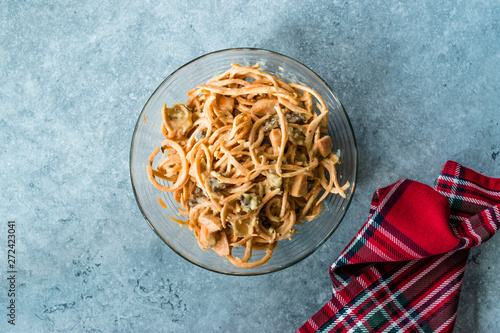 Spiralized Raw Sweet Potato Salad with Tahini / Tahin Sauce, Walnut and Cheese in Glass Bow.l. photo