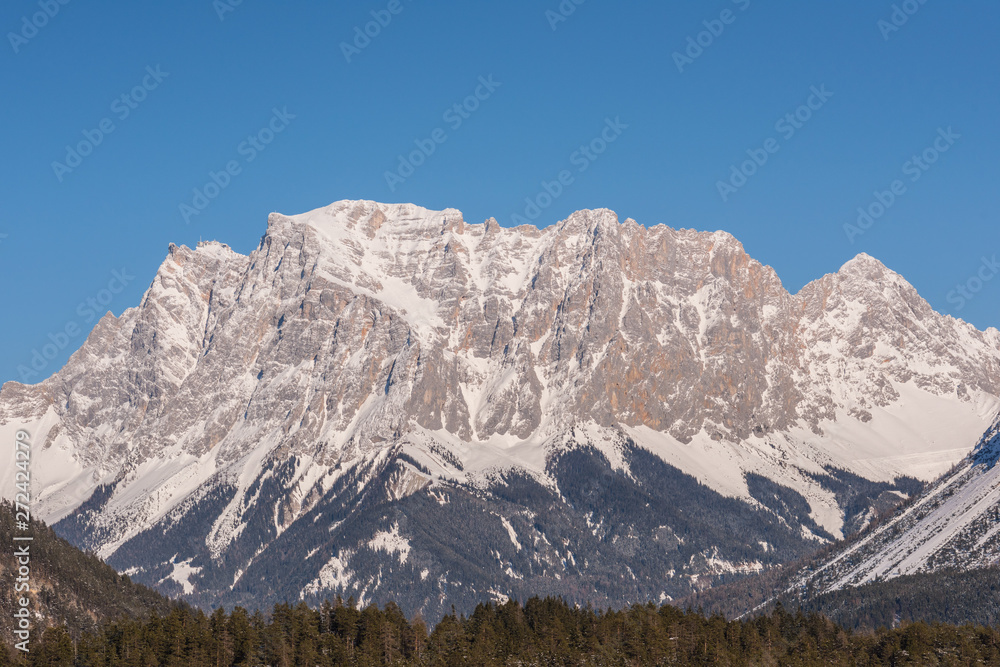 Germany highest mountain the Zugspitze..In winter, the mountain is full of beauty, with many trees in the valley and snow on top of the mountain.