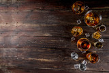 Assortment various hard and strong alcoholic drinks in different glasses: vodka, cognac, tequila, brandy and whiskey, grappa, liqueur, vermouth, tincture, rum, etc. Wooden background copy space