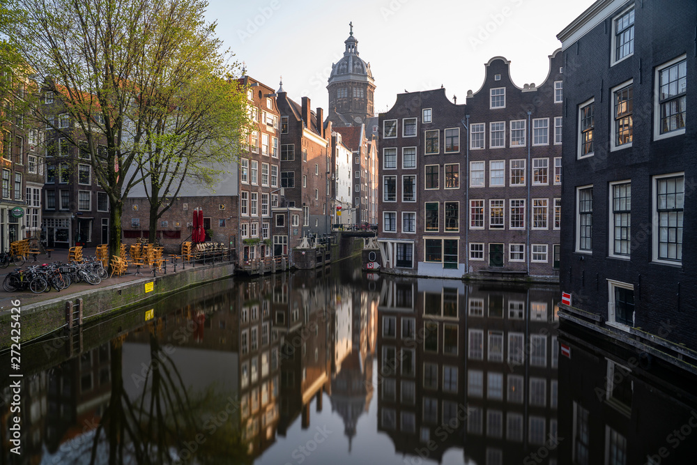 St Nicolaaskerk with canal houses in Amsterdam in the Netherlands St Nicolaaskerk with canal houses in Amsterdam in the Netherlands