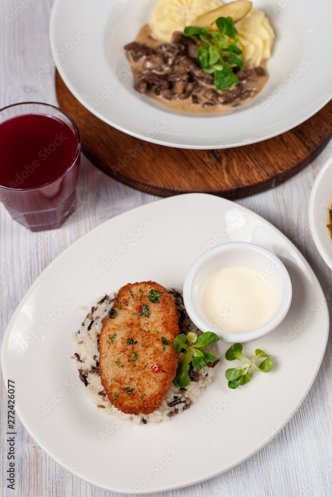 Crunchy chicken cutlet with steamed rice as a part of healthy lunch Crunchy chicken cutlet with steamed rice as a part of healthy lunch