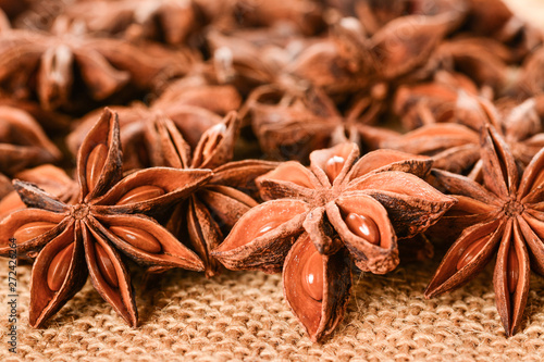 Star anise. Some star anise fruits with seeds 6. Macro close up on the jute burlap canvas.