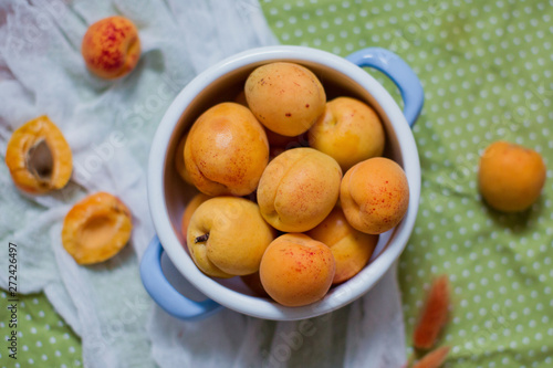 Delicious ripe apricots in blue vintage saucepan