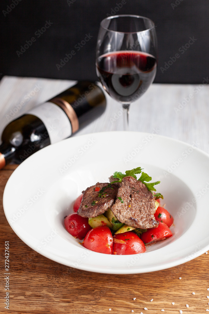 Mini bbq pork steaks with mashed potatoes and fragrant tomatoes, served with red wine Mini bbq pork steaks with mashed potatoes and fragrant tomatoes, served with red wine
