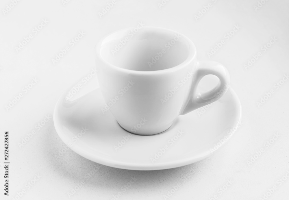 white empty coffee cup with saucer standing on a white background, contrasting clear shadows from it, business concept, white dishes for coffee white empty coffee cup with saucer standing on a white background, contrasting clear shadows from it, business concept, white dishes for coffee
