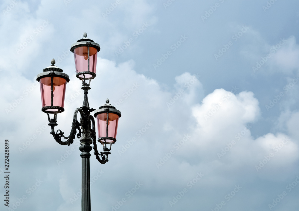 old street lamp on background of blue sky