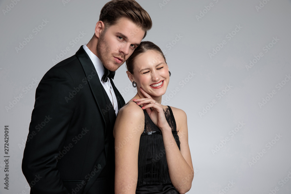 Elegant couple posing while she is laughing Elegant couple posing while she is laughing
