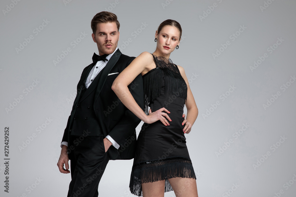 Motivated couple posing leaning on each other Motivated couple posing leaning on each other