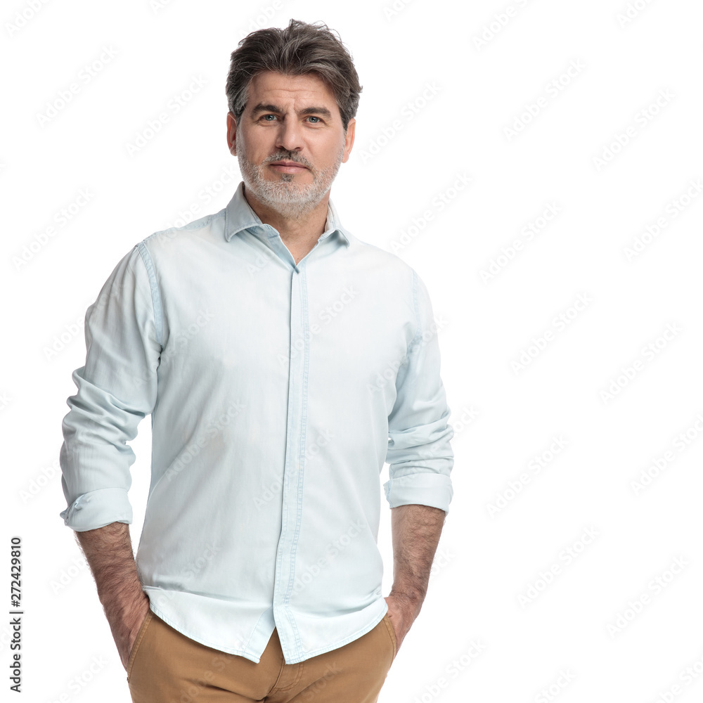 Casual confident man holding both hands in his pockets Casual confident man holding both hands in his pockets