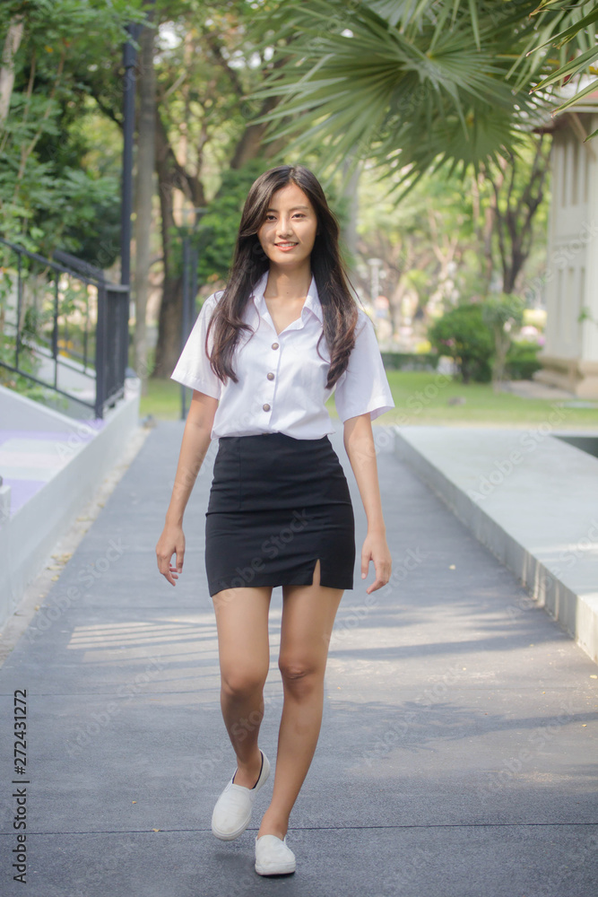 Obraz premium Portrait of thai adult student university uniform beautiful girl relax and smile