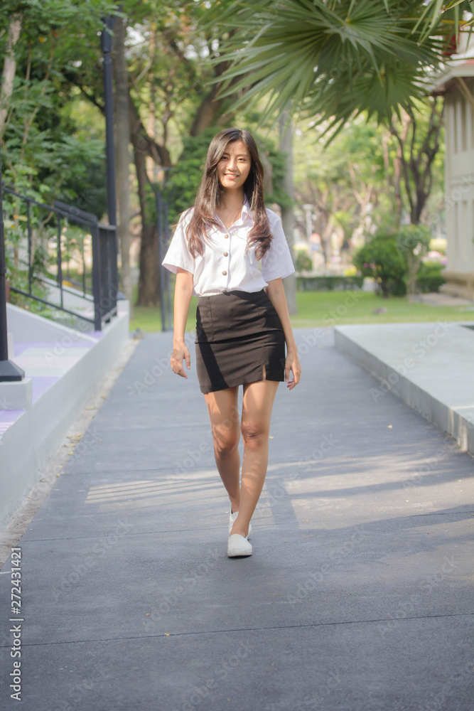 Obraz premium Portrait of thai adult student university uniform beautiful girl relax and smile
