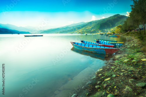 Blue Sky and calm Lake with colorful Boats.