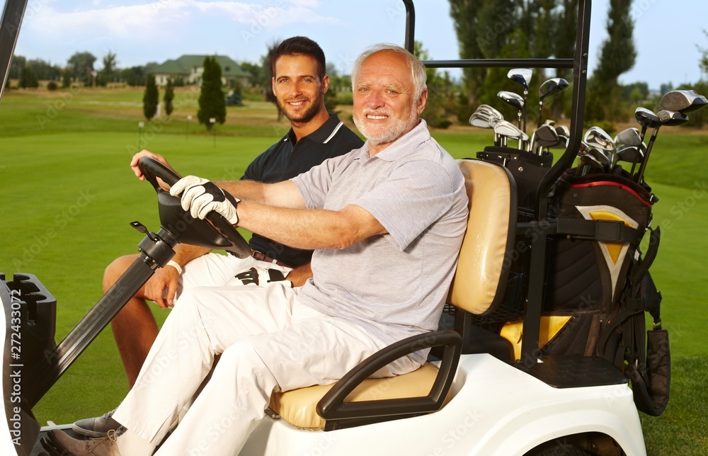 Happy golfers in golf cart