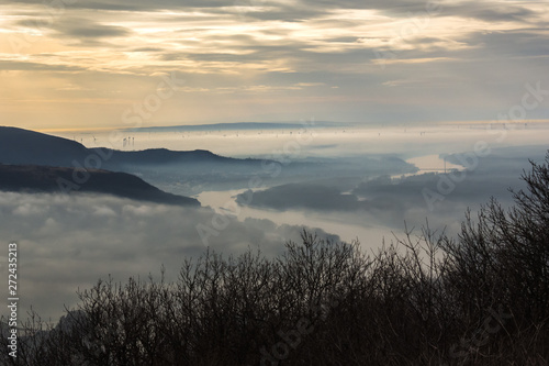 Photography Morava river winding through fields and foothills of Carpathian Mountains, marking Slovak-Austrian border