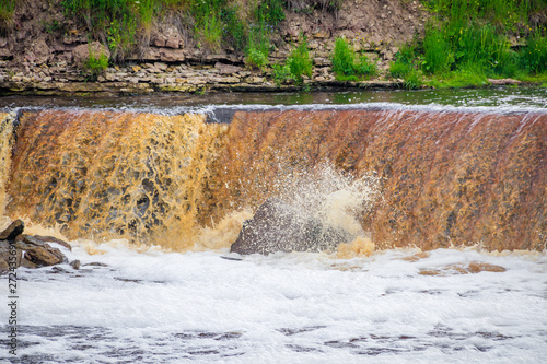 Sablinsky waterfalls. Little waterfall. The brown water of the waterfall.. Thresholds on the river. Strong water flow. Jets of water. Fast current photo