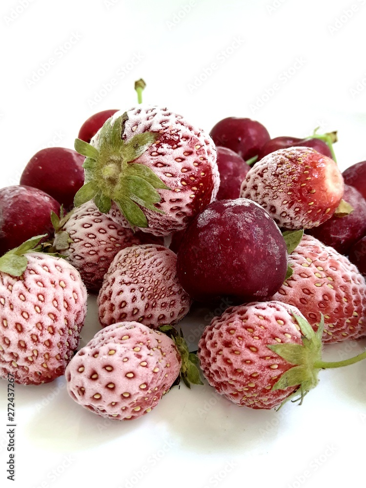 Frozen berries of strawberries and cherries Frozen berries of strawberries and cherries