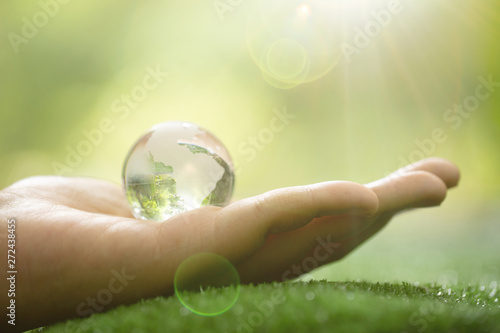 Close up of Green Planet in Your Hands. Save Earth. Environment Concept.