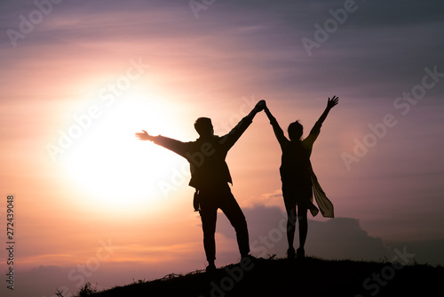 Silhouette of couple with sunset or sunrise background