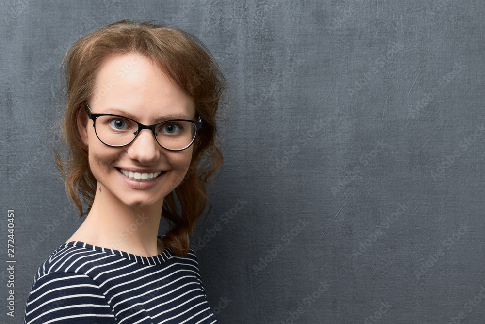 Portrait of happy young woman with glasses smiling broadly Portrait of happy young woman with glasses smiling broadly