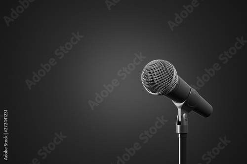 Front view of the black microphone with stand on the black background. Concert and karaoke concept.