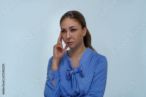 Portrait of girl on gray background in business financial style. Beautiful woman is looking and thinking about scientific things