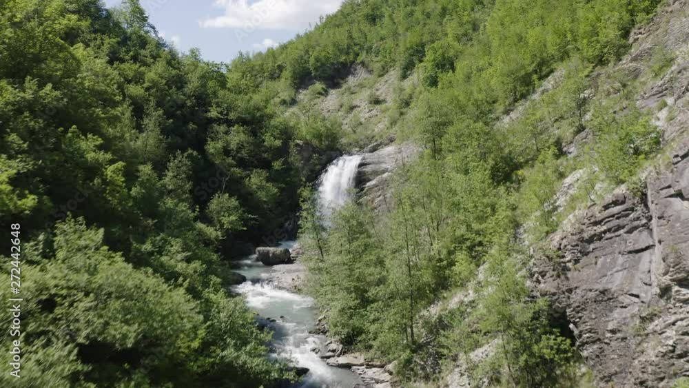 Aerial shot of drone rising over Secchiello stream in Val d’Asta in Reggio Emilia in Italy flying towards Golfarone Waterfall. Aerial shot of drone rising over Secchiello stream in Val d’Asta in Reggio Emilia in Italy flying towards Golfarone Waterfall.