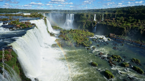 Cascade of Iguazu Waterfalls with rainbow, Iguacu River. Located between Argentina and Brazil. 
