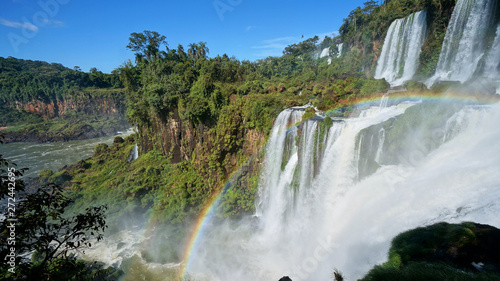 Cascade of Iguazu Falls with rainbow, Iguacu River. Located between Argentina and Brazil. Largest waterfalls system in the world.