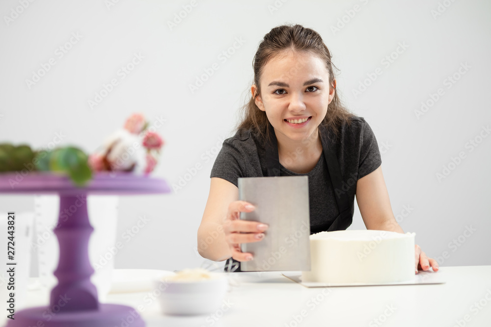 White smooth cylindrical cake blank. The confectioner creates the shape of a pastry spatula. White smooth cylindrical cake blank. The confectioner creates the shape of a pastry spatula.