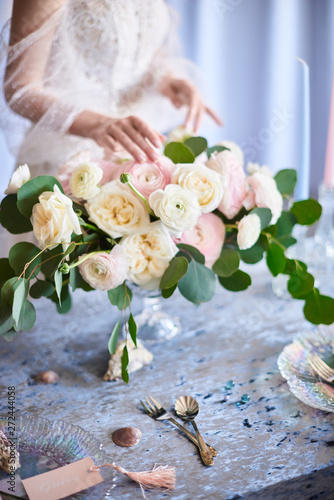 Very nice young woman holding big and beautiful colorful flower wedding bouquet. Blush Italian Cloony Ranunculus. photo