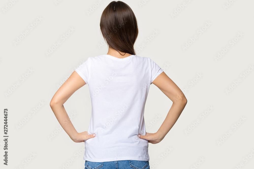 Rear view female wearing white t-shirt hold hands on waist Rear view female wearing white t-shirt hold hands on waist