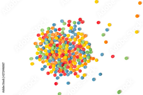 Сolorful round sprinkles or sugar confetti on white background. Sugar sprinkle dots, decoration for cake and bakery. 