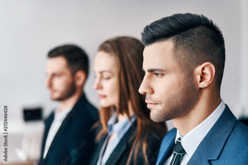 Portrait of group of young business people in a row in office. Portrait of group of young business people in a row in office.
