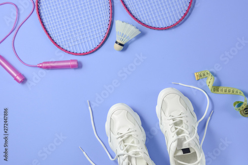 Sports flat lay with shuttlecock and badminton racket, skipping rope,  sneakers and measuring tape on green background. Fitness, sport and healthy  lifestyle concept. Stock Photo by ©JuraJarema 274437496