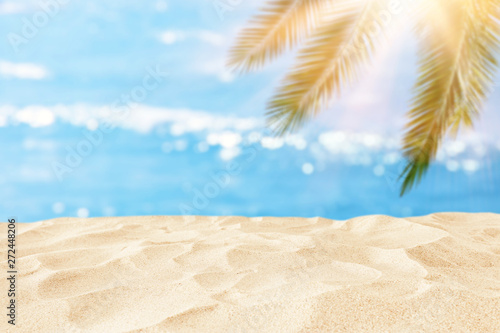 Fototapeta Naklejka Na Ścianę i Meble -  Empty sand beach in front of summer sea and palm tree background with copy space