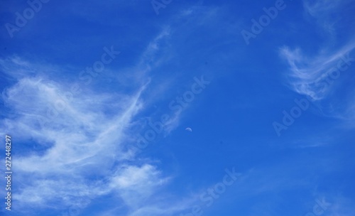 Brilliant Blue Sky with Clouds and the Moon