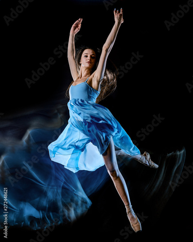 one caucasian young woman ballet dancer dancing isolated on black background with light painting motion blur speed effect