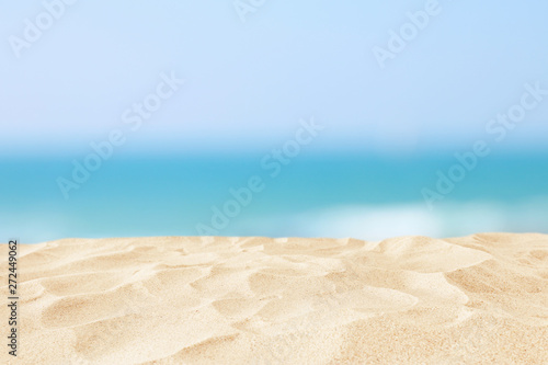 Empty sand beach in front of summer sea background with copy space