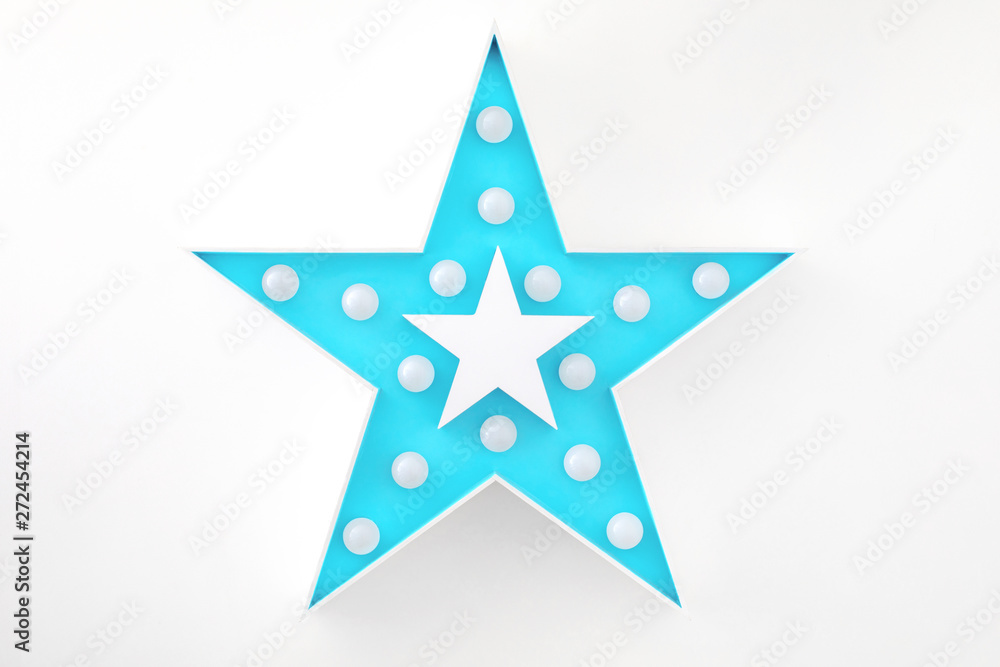 Obraz premium blue decorative star with lots of lights on white background
