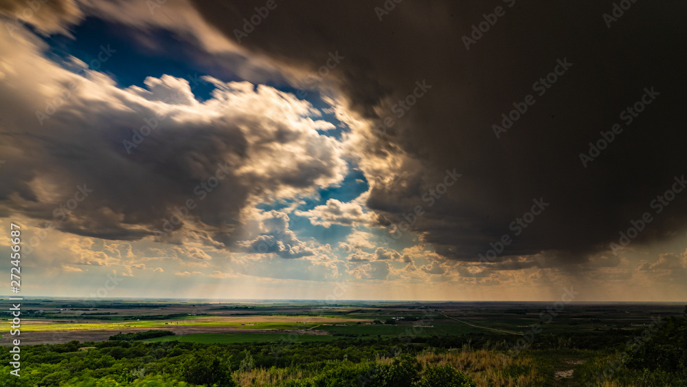 Storm clouds over vast prairies Ranches and farms bold sky powerful force of nature