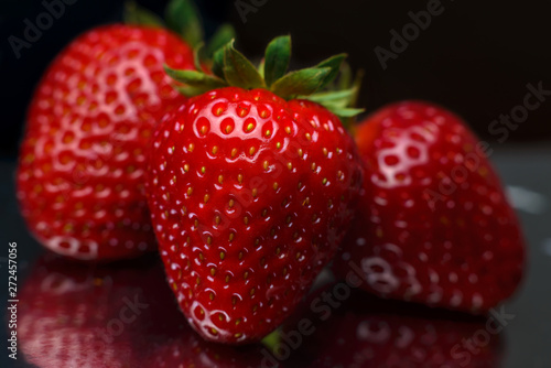 Wallpaper Mural Strawberry closeup. Macro image of fresh strawberries on dark background Torontodigital.ca