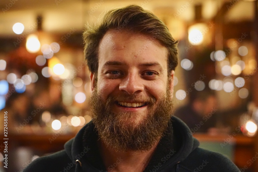 Close up portrait of a Brazilian man with blue eyes and a beard smiling Close up portrait of a Brazilian man with blue eyes and a beard smiling