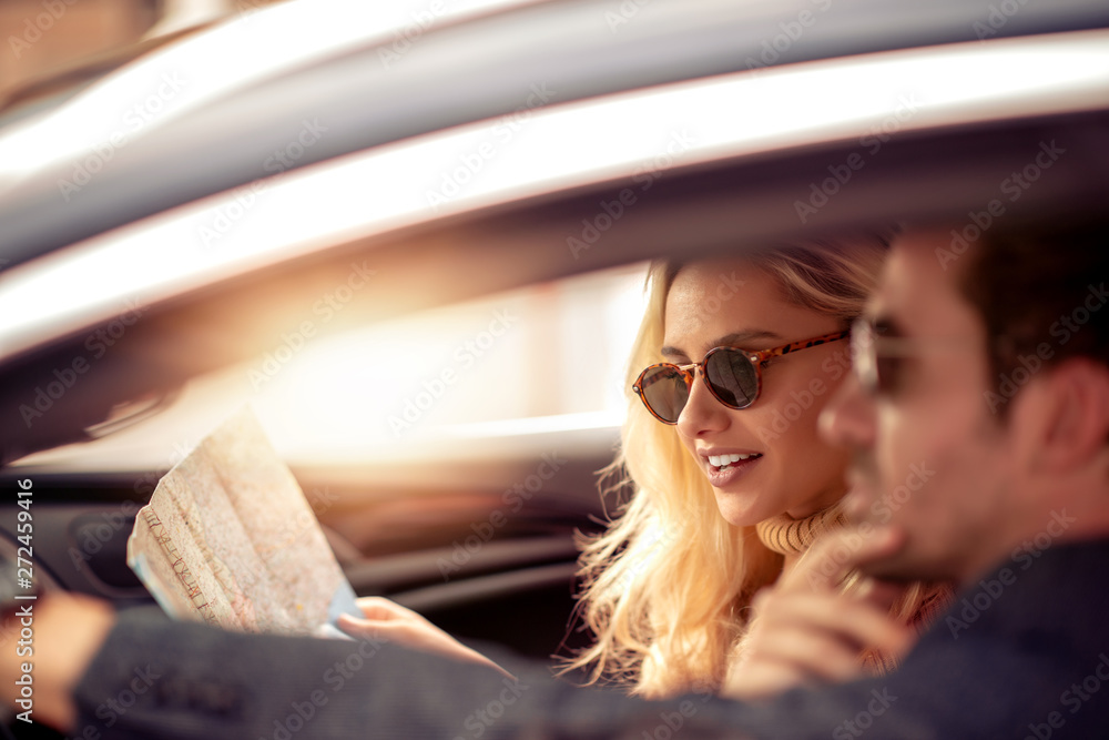Couple looking at map in car