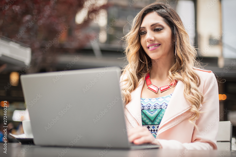 Young woman blogger freelancer in outdoor cafe with computer laptop Young woman blogger freelancer in outdoor cafe with computer laptop