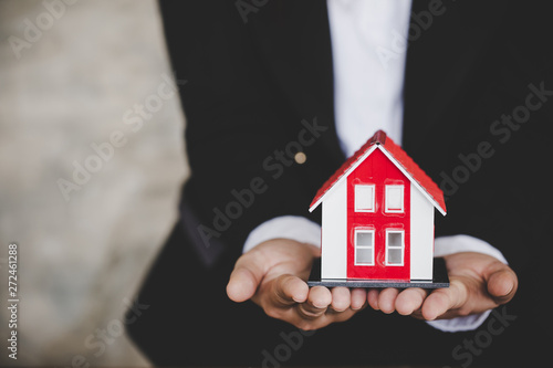Real Estate Agent Holding House Model, Real Estate Concept