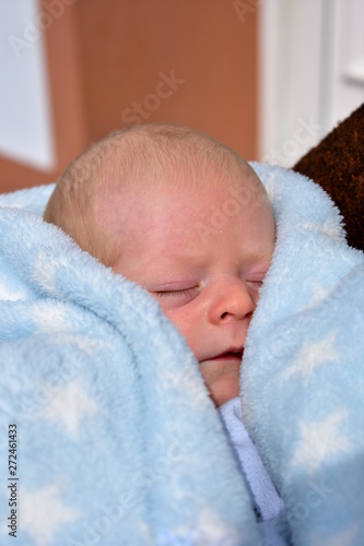 Newborn baby with a blue blanket. Blonde boy. © JB