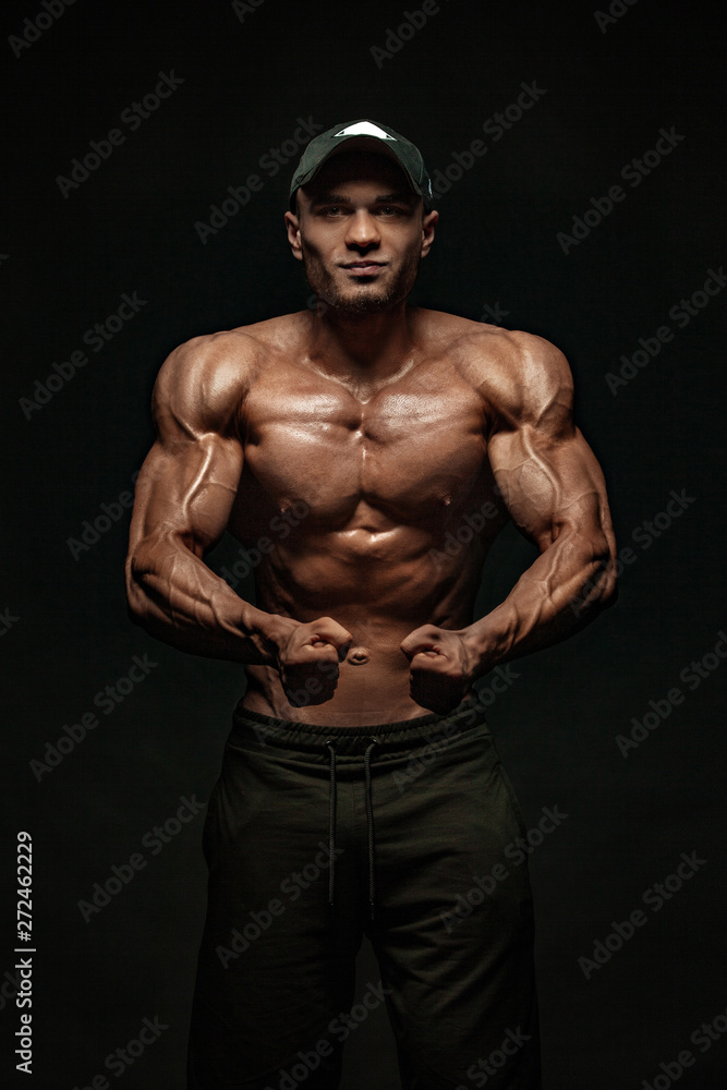 Fototapeta premium Bodybuilding competitions on the scene. Man sportsmen bodybuilder physique and athlete. Fitness motivation.